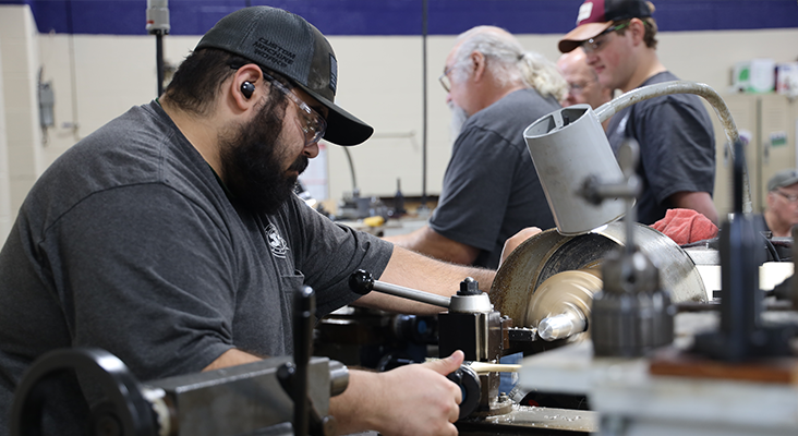 Student in PMT class working on machine.