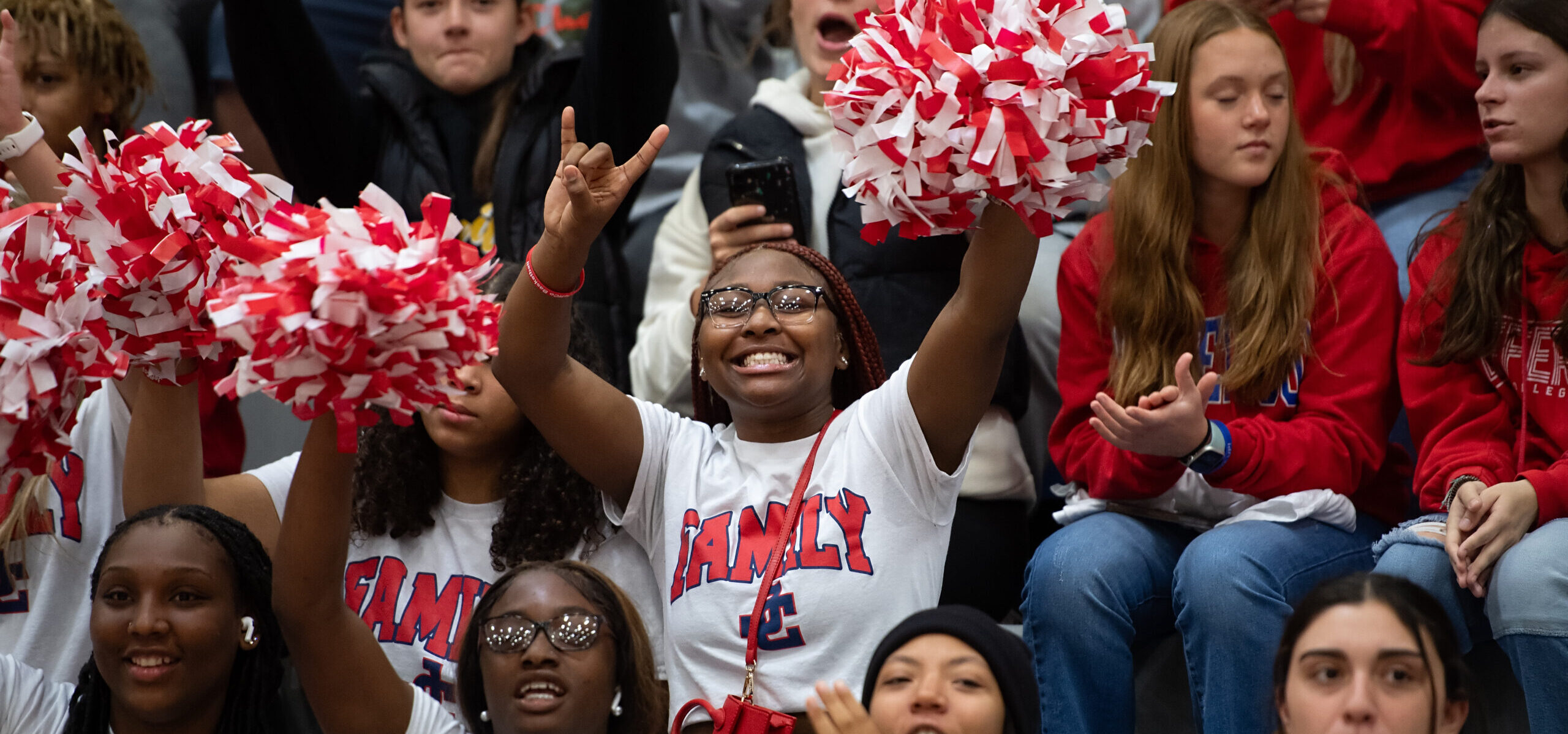 Students cheering at basketball game.