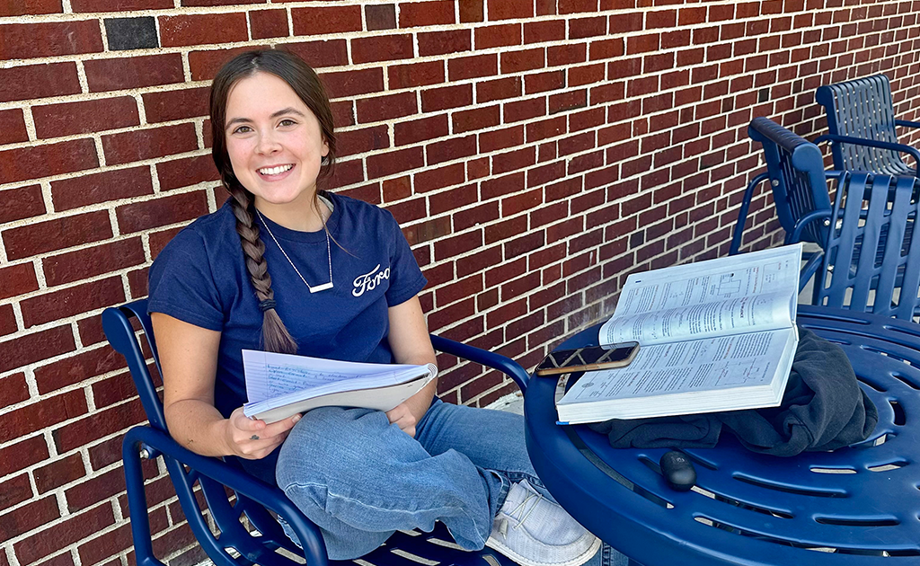 Student studying outside.