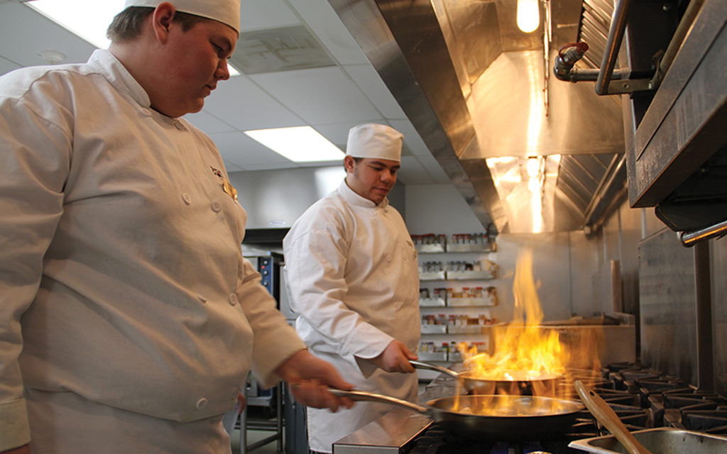 Students cooking food.