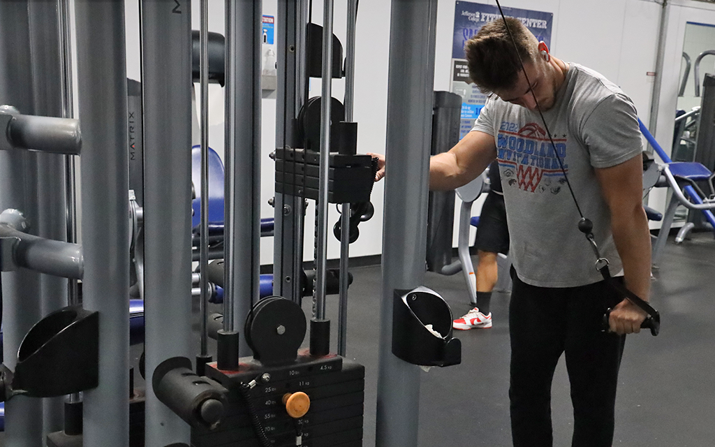 Student working out in fitness center.